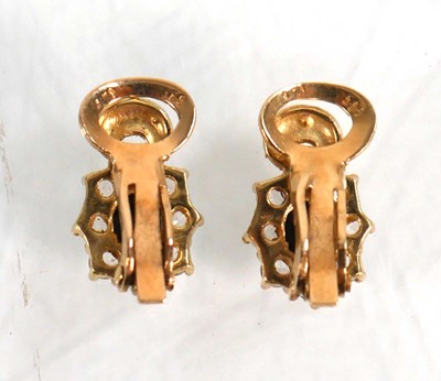 Lot 626 - A pair of 14ct yellow gold ear clips, each set...