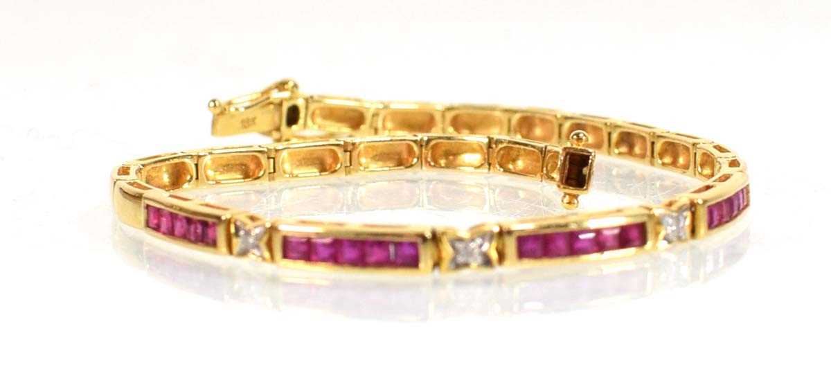 Lot 630 - An 18ct yellow gold tennis type bracelet set...