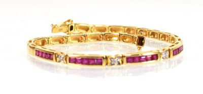 Lot 630 - An 18ct yellow gold tennis type bracelet set...