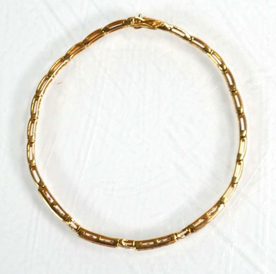 Lot 630 - An 18ct yellow gold tennis type bracelet set...