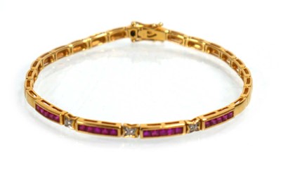Lot 630 - An 18ct yellow gold tennis type bracelet set...