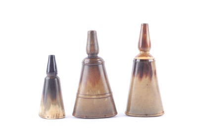 Lot 1043 - Three oval horn powder flasks with screw tops