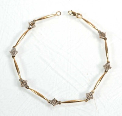 Lot 632 - A 9ct yellow gold bracelet set seven sections...
