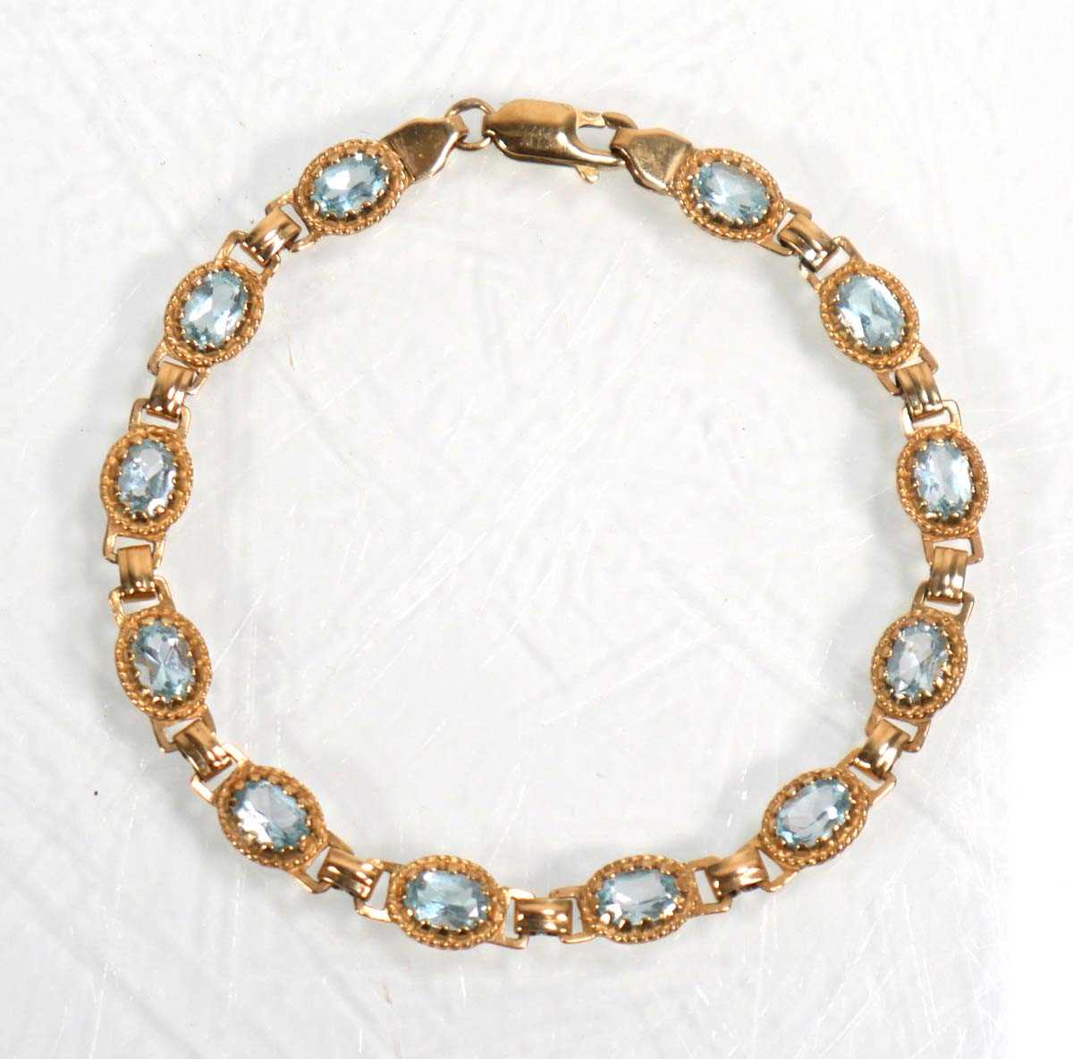 Lot 633 - A 9ct yellow gold bracelet set twelve sections...