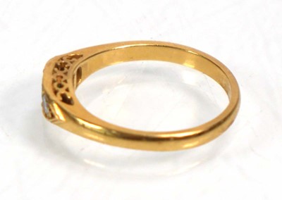 Lot 637 - An 18ct yellow gold ring set emerald and two...