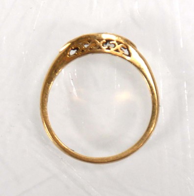 Lot 637 - An 18ct yellow gold ring set emerald and two...