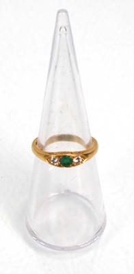 Lot 637 - An 18ct yellow gold ring set emerald and two...