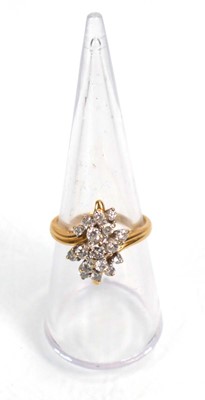 Lot 638 - An 18ct yellow gold cluster ring set seventeen...