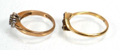 Lot 640 - An 18ct yellow gold crossover ring set blue...
