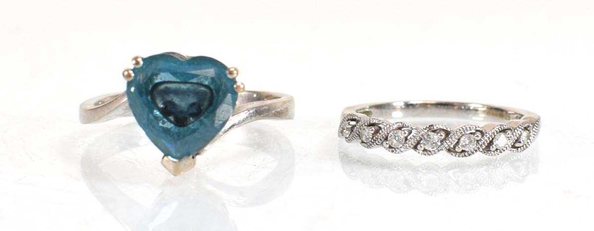 Lot 643 - A 14ct white gold ring set heart shaped blue...