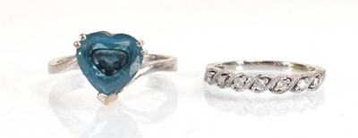 Lot 643 - A 14ct white gold ring set heart shaped blue...