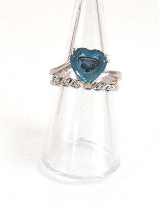 Lot 643 - A 14ct white gold ring set heart shaped blue...