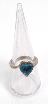 Lot 643 - A 14ct white gold ring set heart shaped blue...