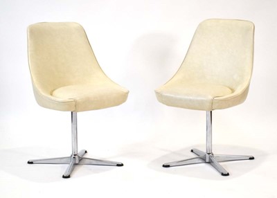 Lot 37 - A pair of 1960/70's cream vinyl tub chairs on...