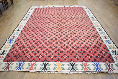 Lot 39 - A 20th century flat-weave carpet, the red...