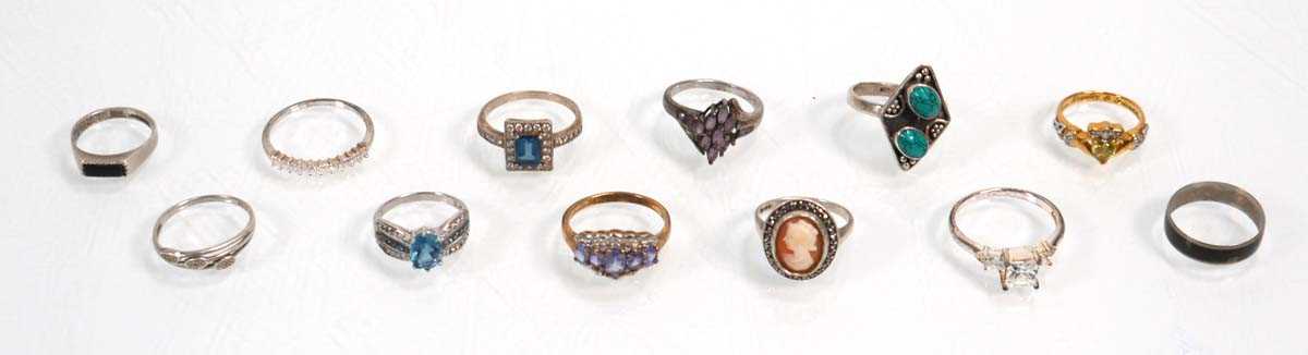 Lot 648 - Twelve silver dress rings including an half...