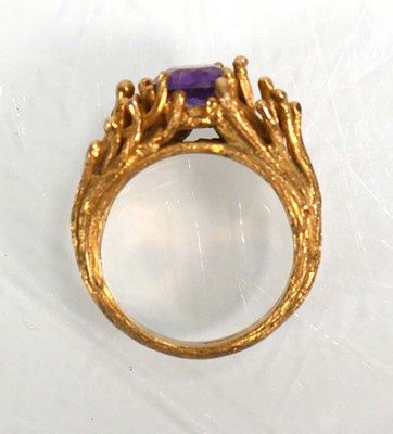 Lot 653 - A 9ct yellow gold ring set oval purple stone...