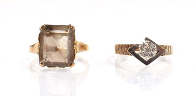 Lot 656 - A 9ct yellow gold ring set smoky quartz, ring...