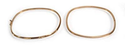 Lot 661 - Two 9ct yellow gold hinged bracelets, overall...