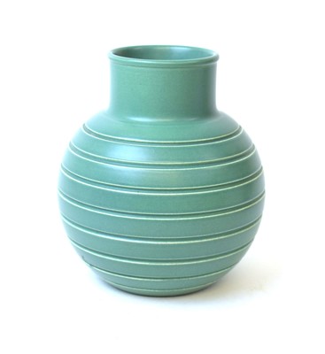Lot 200 - Keith Murray for Wedgwood, a green glazed vase...