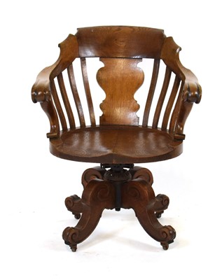 Lot 26 - A 20th century oak captain's elbow chair on a...