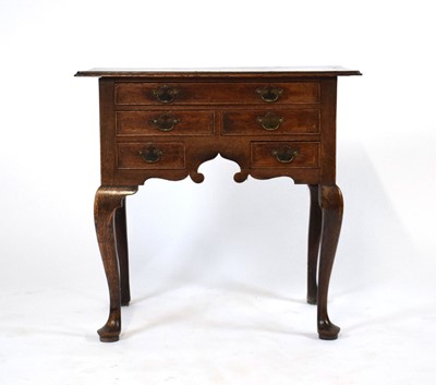Lot 47 - A George II/III oak and triple banded lowboy...