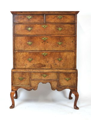 Lot 50 - A George II walnut and feather banded chest-on-...