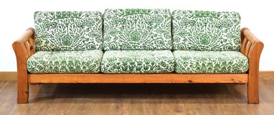 Lot 160 - A 1970's pine framed three-seater sofa with...