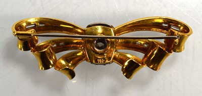Lot 671 - An 18ct yellow gold brooch of bow design...