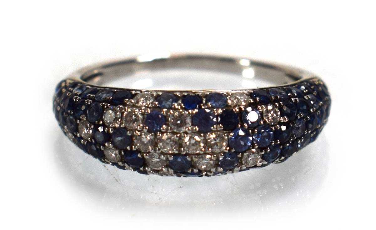 Lot 674 - A 14ct white gold bombe ring set small...