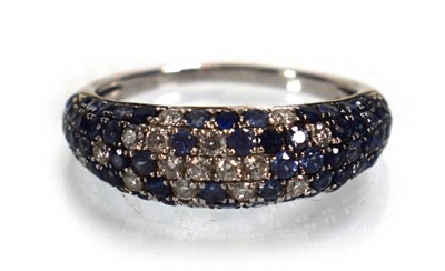 Lot 674 - A 14ct white gold bombe ring set small...