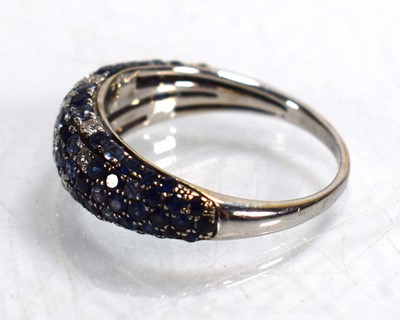 Lot 674 - A 14ct white gold bombe ring set small...