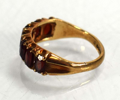 Lot 675 - A 9ct yellow gold ring set seven oval garnets,...