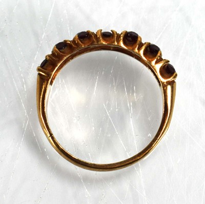 Lot 675 - A 9ct yellow gold ring set seven oval garnets,...