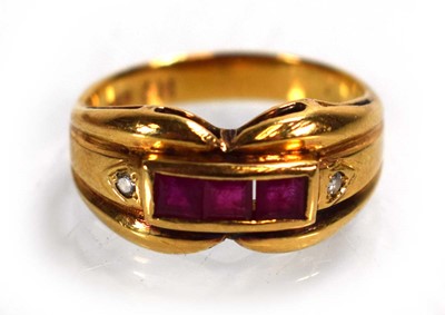 Lot 676 - An 18ct yellow gold ring set three square cut...