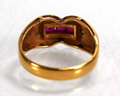Lot 676 - An 18ct yellow gold ring set three square cut...