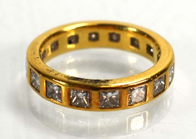 Lot 678 - A yellow metal full eternity ring set princess...