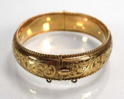 Lot 683 - A 9ct yellow gold florally engraved hinged...