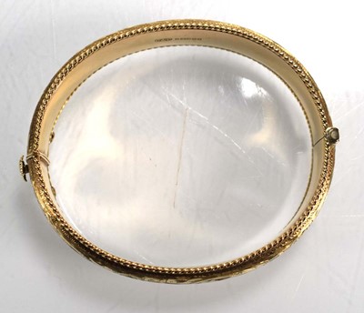Lot 683 - A 9ct yellow gold florally engraved hinged...