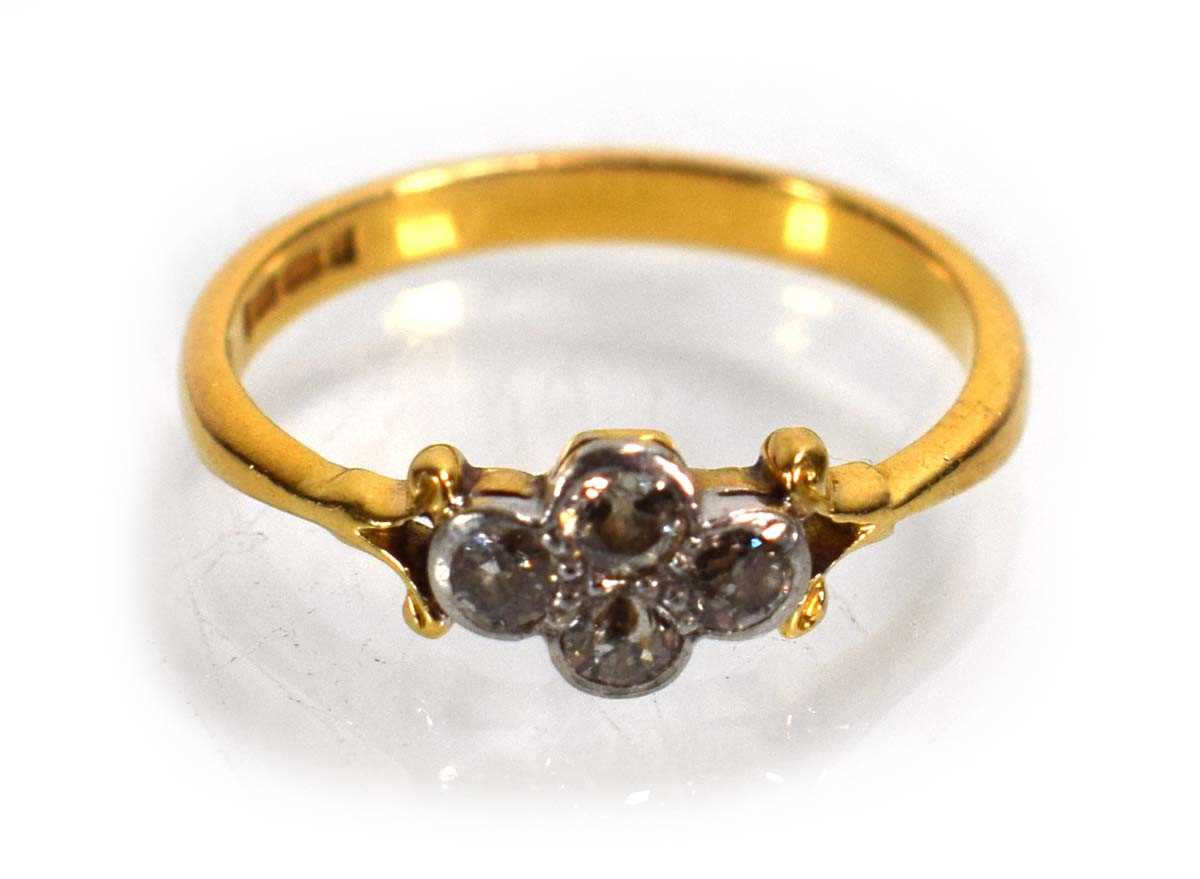 Lot 686 - A 22ct yellow gold ring set four small...