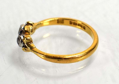 Lot 686 - A 22ct yellow gold ring set four small...