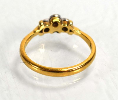 Lot 686 - A 22ct yellow gold ring set four small...