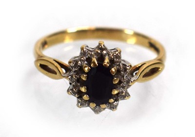 Lot 687 - A 9ct yellow gold sapphire and diamond cluster...