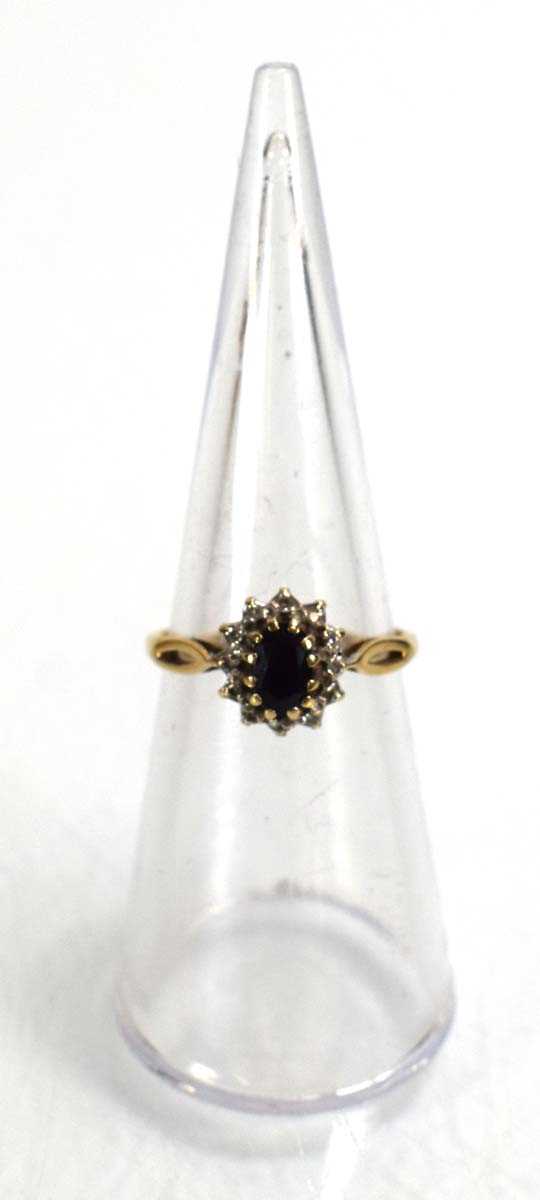 Lot 687 - A 9ct yellow gold sapphire and diamond cluster...