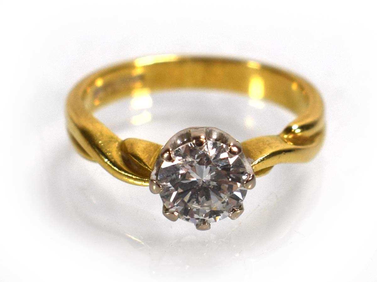 Lot 691 - An 18ct yellow gold ring set brilliant cut...
