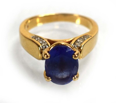 Lot 692 - A 14ct yellow gold ring set oval tanzanite in...
