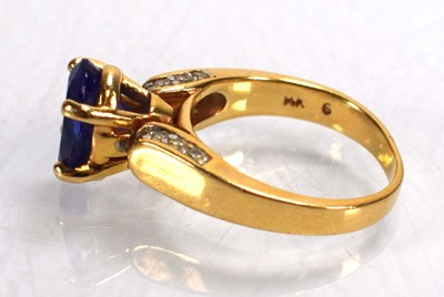 Lot 692 - A 14ct yellow gold ring set oval tanzanite in...