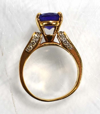 Lot 692 - A 14ct yellow gold ring set oval tanzanite in...