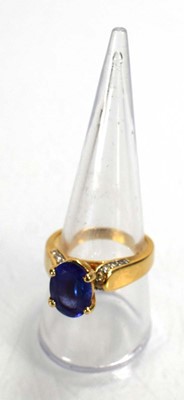 Lot 692 - A 14ct yellow gold ring set oval tanzanite in...