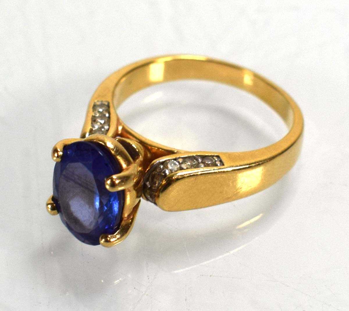 Lot 692 - A 14ct yellow gold ring set oval tanzanite in...